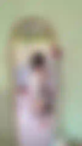 Curly haired girl, sexy short skirt in front of mirror