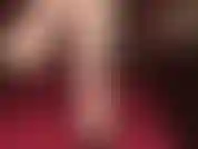 Con i piedi nudi e le scarpe penzolanti di pelle nera.