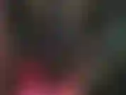 Una mistress in lattice, con un abito attillato in gomma nera e stivali sexy con tacco a spillo.